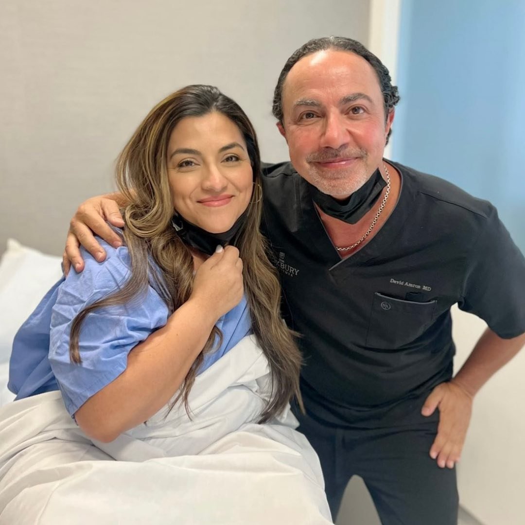 Dr David Amron with arm around patient